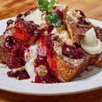 Cannoli French Toast · Challah French Toast topped with cannoli cream, wild berry sauce, cannoli shell crumbles, wh...