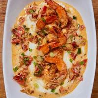 Shrimp And Grits · Shrimp, garlic, onion, pico de gallo and bacon served over pepper jack cheesy grits, topped ...
