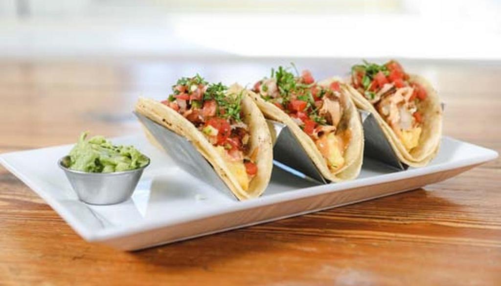 Breakfast Tacos · Three soft, corn tortilla, stuffed tacos served with pepper jack, scrambled eggs topped with chipotle mayo, homies and pico de gallo.