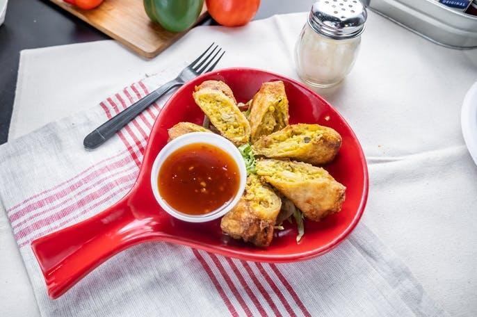 Jalapeno Popper Egg Rolls · Egg Rolls poppers stuffed with jalapeno, cream cheese and cheddar cheese and served with a sweet & spicy dipping sauce