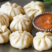 Vegetable Momo (Nepalese Appetizer) · Himalayan Style Steam Vegetable dumpling. Served with spicy tomato chutney & sesame peanut c...