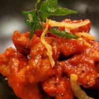 Chicken 65 · Marinated boneless chicken sautéed with curry leaves, mustard & hot garlic sauce.