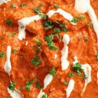 Butter Chicken · Tender boneless chicken roasted in tandoor and simmered with cream, tomato sauce, honey & sp...