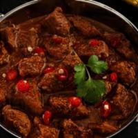 Lamb Vindaloo · Boneless lamb spicy curried stew curry cooked with tomato red chilli, potatoes, vinegar, gar...