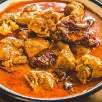 Goat Rogan Josh · Bone-in goat meat cooked with yogurt based curry sauce, onion, tomato, ginger, garlic & grou...