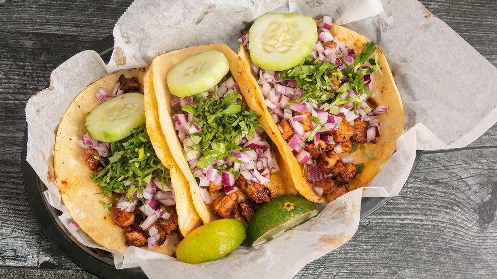 Mexican Street Tacos · Three soft corn tortilla tacos filled with your choice of meat topped with chopped cilantro and onions.
