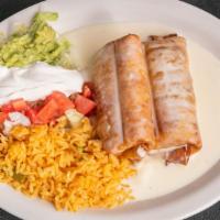 Soft Or Fried Chimichangas · Two deep-fried flour tortillas filled with your choice of shredded beef or chicken and toppe...