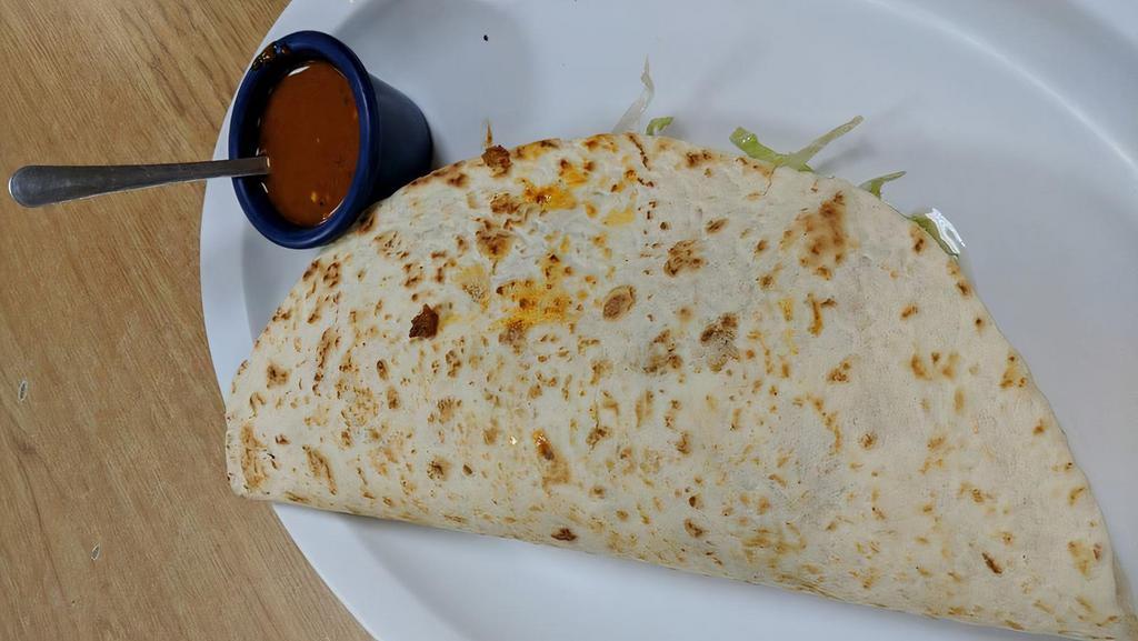 Quesadilla · Flour tortilla with cheese inside and lettuce, sour cream and more cheese with the choice of meat.