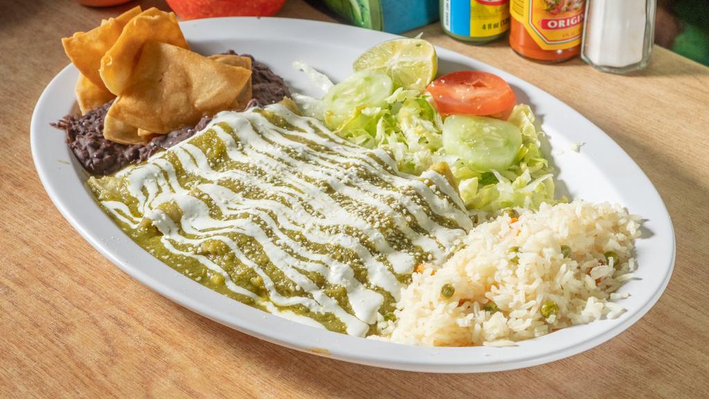 Enchiladas Verdes · Green sauce enchiladas comes a platter of four tortillas with chicken inside topped with sauce then sour cream and cheese.