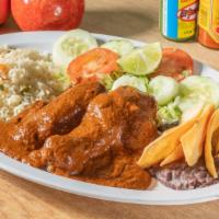 Mole Poblano  · chicken thigh and breast topped with mole along with rice, beans  ,a salad and tortillas