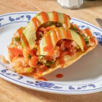 Shrimp Tostada · Flat fried tortilla topped with shrimp mixed with tomatoes, onions, cilantro and a sauce on ...