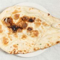 Naan · Traditional clay oven baked white bread.