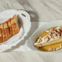 Baked Brie · With toasted almonds and honey served with baguette.