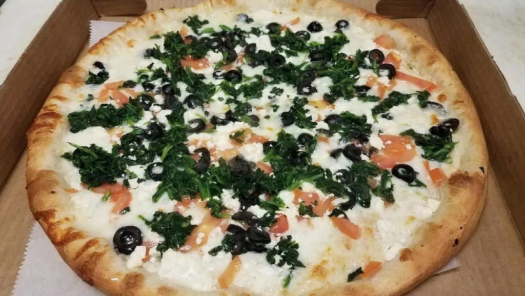Greek Pizza · White pizza with spinach, fresh tomato, olives, roasted garlic and feta cheese.