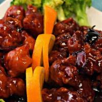 Tiger & Phoenix · Spicy. General Tso's chicken on the side and tangerine beef on the other side. Served with s...