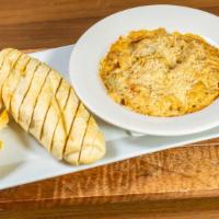 Crab & Artichoke Dip · Creamy dip loaded with crab meat and artichokes, served with Milano bread