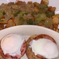 Eggs Benedict Breakfast · Two poached eggs and two pieces of Canadian bacon on top of a toasted English muffin, topped...