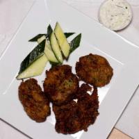 Kolokithokeftedes · Zucchini croquettes filled with fresh mint, feta, and onions and served with tzatziki. Veget...