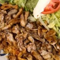 Arroz Con Pollo · Marinated grilled strips of chicken over a bed of rice topped with mild ranchero sauce and c...