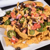 Nachos · Tortilla chips piled high with fresh pico, jalapenos, cilantro lime crema, and cheese.