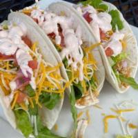 Spicy Chicken Tacos (3) · soft flour tortillas stuffed with pico, lettuce, shredded cheese and cilantro lime crema.