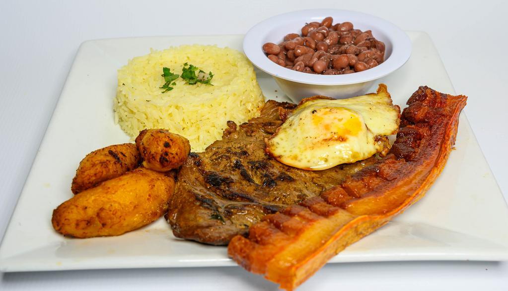 Montañero · Grilled steak, pork strips, fried egg, beans, rice and sweet plantains.