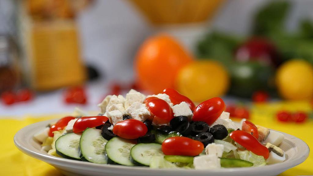 Greek Salad · Romaine lettuce, tomatoes, cucumbers, red onions, olives, feta cheese, and green peppers.