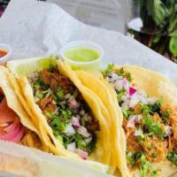 Cochinita Pibil Taco · Yucatan style pulled pork seasoned with achiote, red onion, cilantro, double corn tortilla,l...