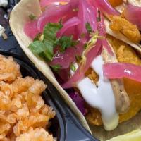 Fish Taco Plate · Two fish  tacos, Includes sides of rice and beans.