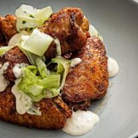 Smoked Chicken Wings · Gluten free. Topped with White BBQ Sauce, Celery Slaw (6 wings served).