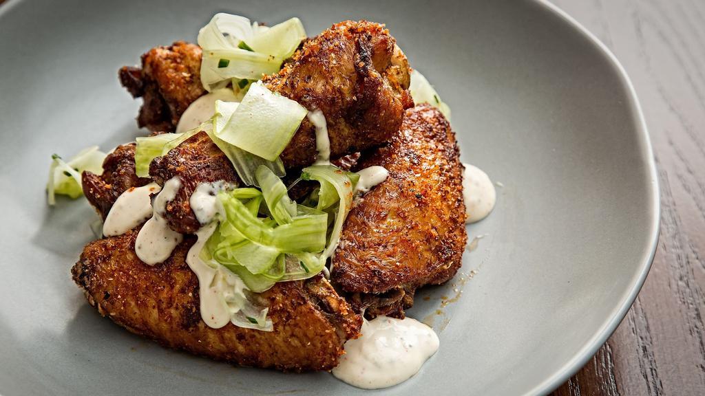 Smoked Chicken Wings · Gluten free. Topped with White BBQ Sauce, Celery Slaw (6 wings served).