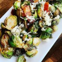 Crispy Brussels Sprouts · Cooked in shallot butter with bacon and sheep's milk cheese.