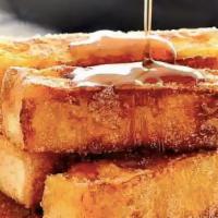 Vegan French Toast Sticks · A tower of 8 french toast stick topped with cinnamon and powered sugar