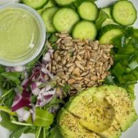 Green Goddess Salad · Arugula, Avocado, Cucumber, Red Onion, Green Peppers and Pepita Seeds with Vegan Goddess Dre...