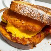 Sunrise Sammies · Scrambled egg, cheddar cheese, apple-wood bacon, and hashbrowns on challah bread.