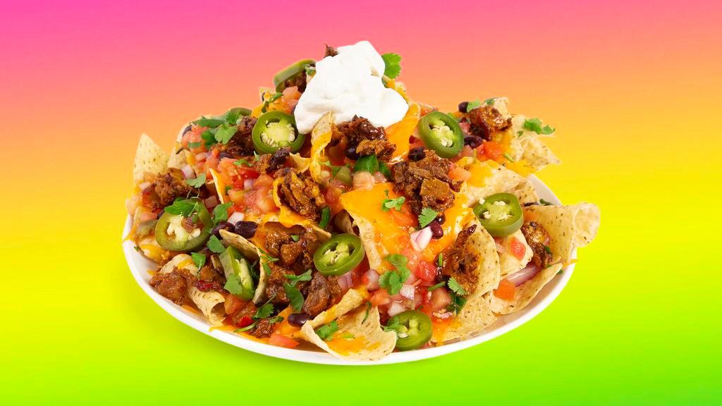 Top-Shelf Al Pastor Nachos · Nachos loaded with al pastor, black beans, cheese, tomatoes, cilantro, and onions.