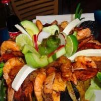 Molcajete Loco · The perfect combination of steak, chicken, mexican sausage, shrimp and pork chops. Served wi...