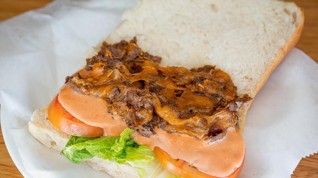 Steak & Cheese Sandwiches · Served warm on our soft coco bread with cheese, lettuce and onions.