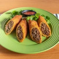 Cheese Steak Eggrolls · Crispy golden brown egg roll filled with steak meat, melted American cheese, fried onions, s...