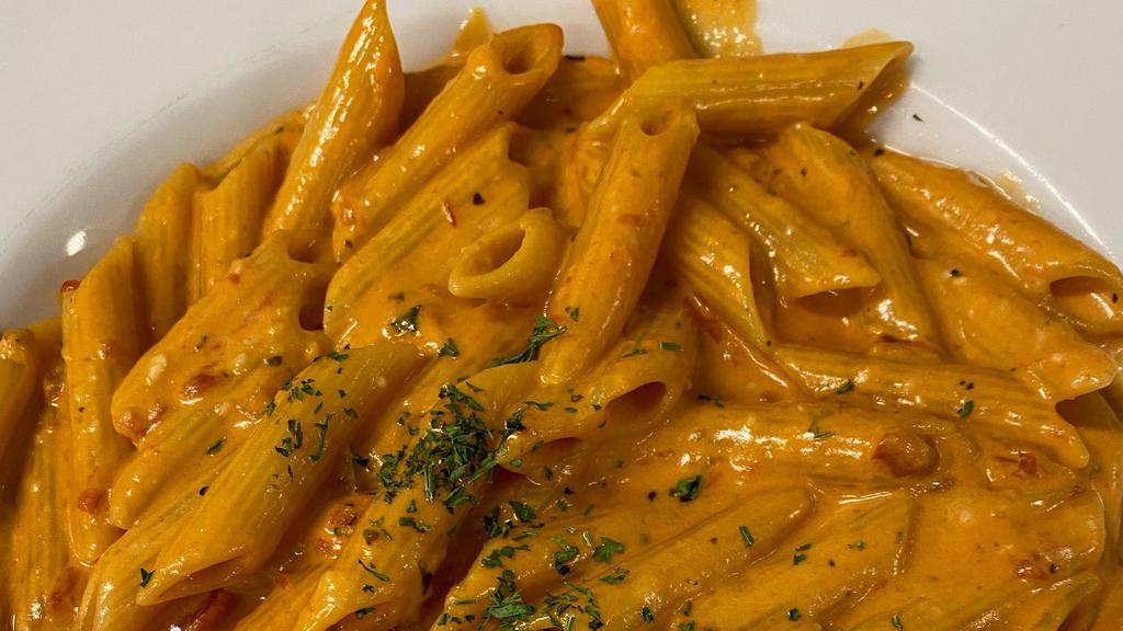 Penne Alla Vodka · Penne pasta tossed with a creamy vodka pink sauce & parmesan cheese.