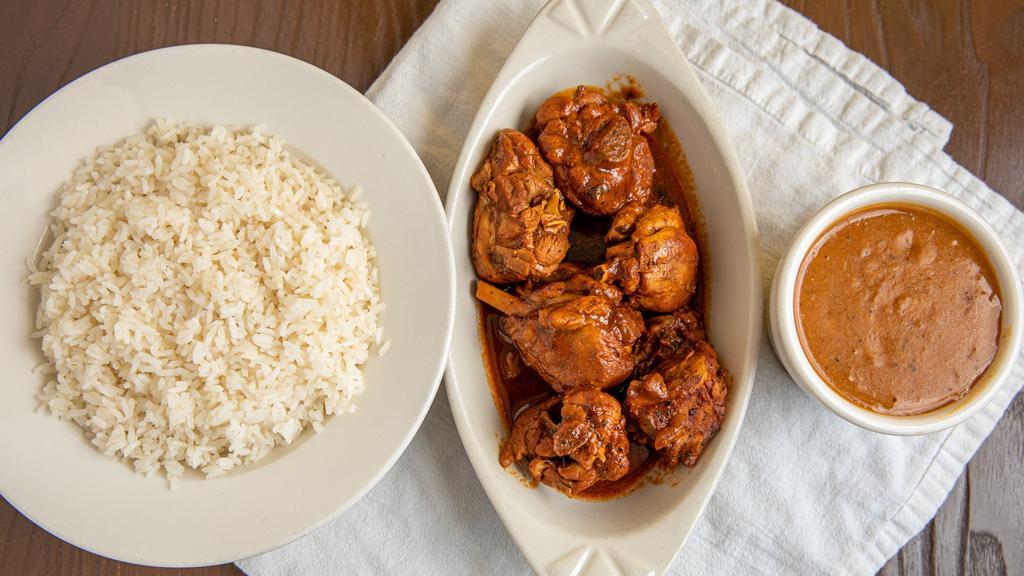 Stew Chicken/Pollo Guisado · Served with rice and beans