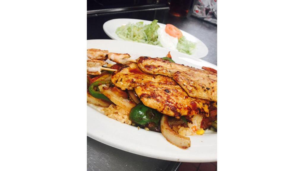 Fiesta Alambre Shish-Kebabs · Marinated chicken breast, shrimps, tomatoes, bell peppers, onions, and mushrooms. Our secret melted cheese on the rice, salad, guacamole, and sour cream on the side.
