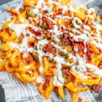 Twisted Fries · Spiral cut fries loaded with jalapeño ranch dressing and topped with melted cheddar cheese, ...