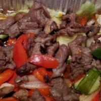 Bo Luc Lac ** · Marinated beef sautéed with onion, cucumber, bell pepper, lettuce and garlic in house specia...