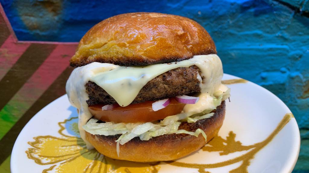 Mom'S Burger · 7 oz. burger with American cheese, lettuce, tomato, onion, horseradish sauce on a brioche bun.