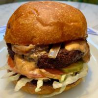 Beyond Mom'S Vegan Burger · Beyond  vegan burger with pickles, lettuce, tomato, fried onion, beyond Mom's sauce on a bri...