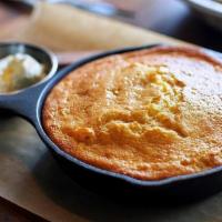 Skillet Cornbread · Sweet & savory cornbread is served with house-churned North Dakota honey butter sprinkled wi...