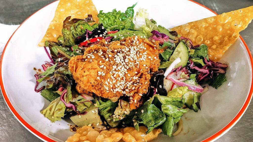 Chinese Fried Chicken Salad · Mixed lettuce with napa cabbage, wontons, peanut noodles, and mint all topped with our signature Chinese fried chicken. Served with a sesame vinaigrette.