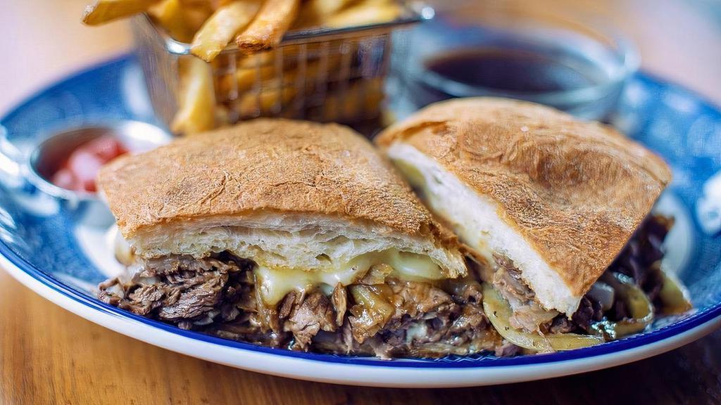 Prime Rib Dip · Slow-roasted and thinly-sliced prime rib topped with caramelized onions, gruyère cheese, and served on our ciabatta with house-made mayonnaise. Perfect for dipping into the accompanying au jus.