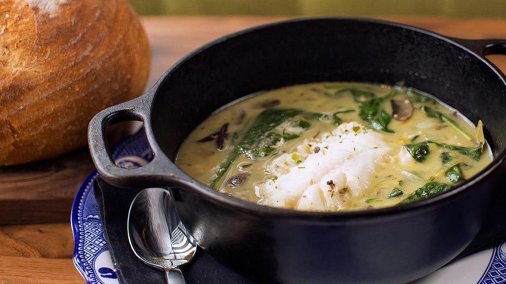 Herb Butter Steamed Cod · An aromatic mix of white fish and vegetables (corn, mushrooms, cannellini beans, leeks, spinach), simmered in vegetable star anise and fennel broth, finished with a touch of herb butter.